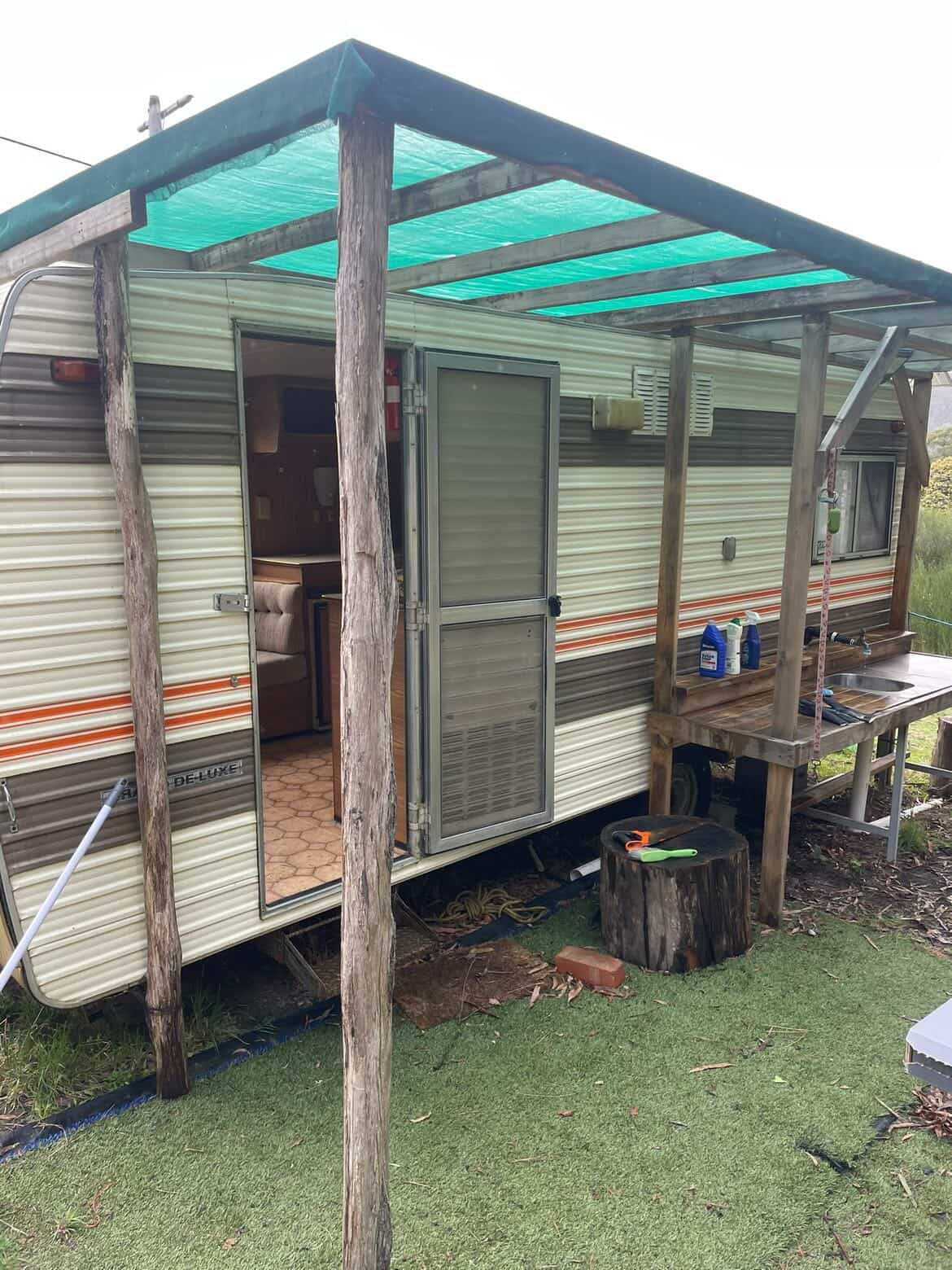 Caravan exterior — before, with shade cloth roof